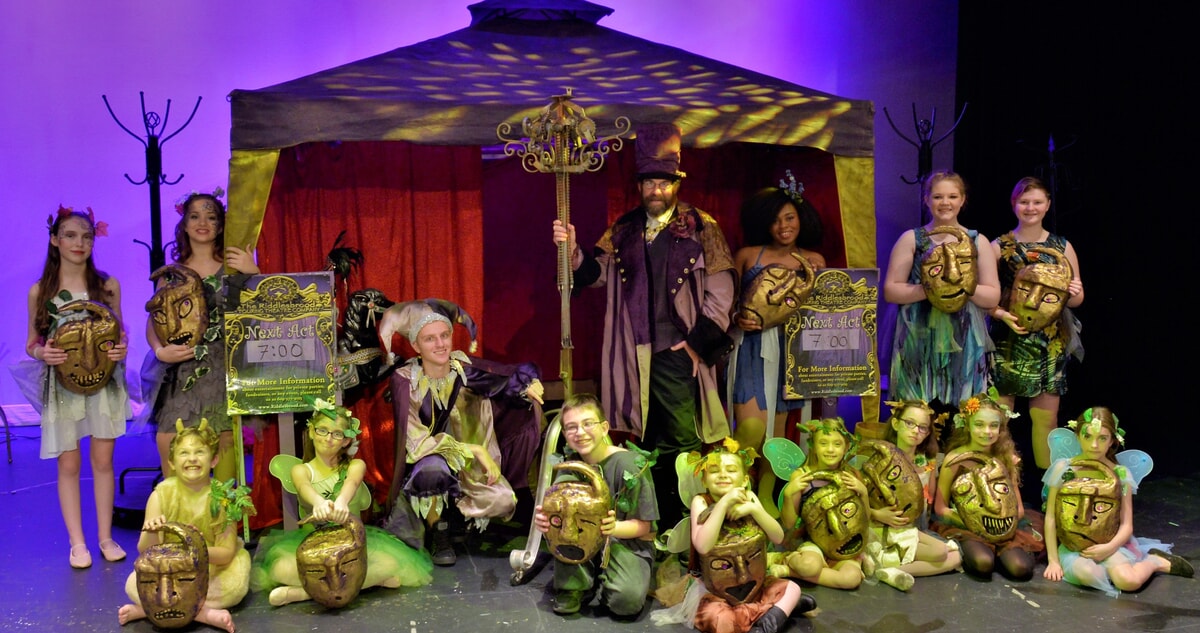 Young performers in fairy costumes practice speaking a custom language designed by the Riddlesbrood conlanger.
