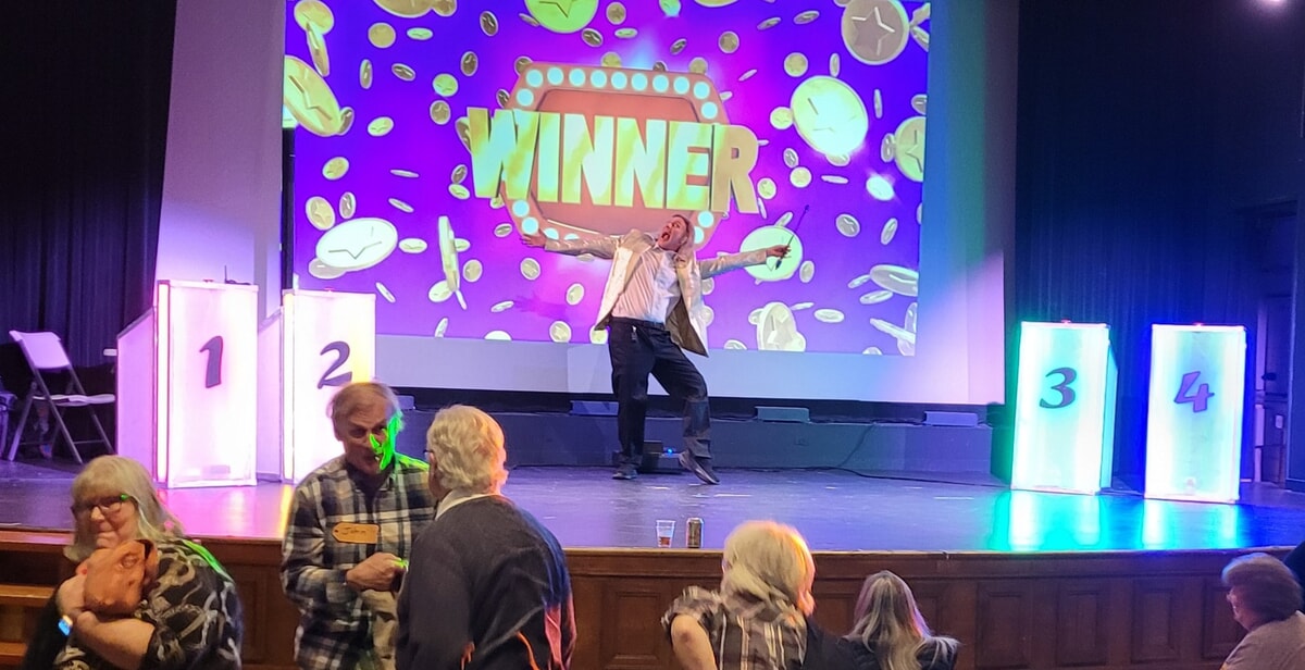 Employees collaborating in a team-building Riddlesbrood game show experience