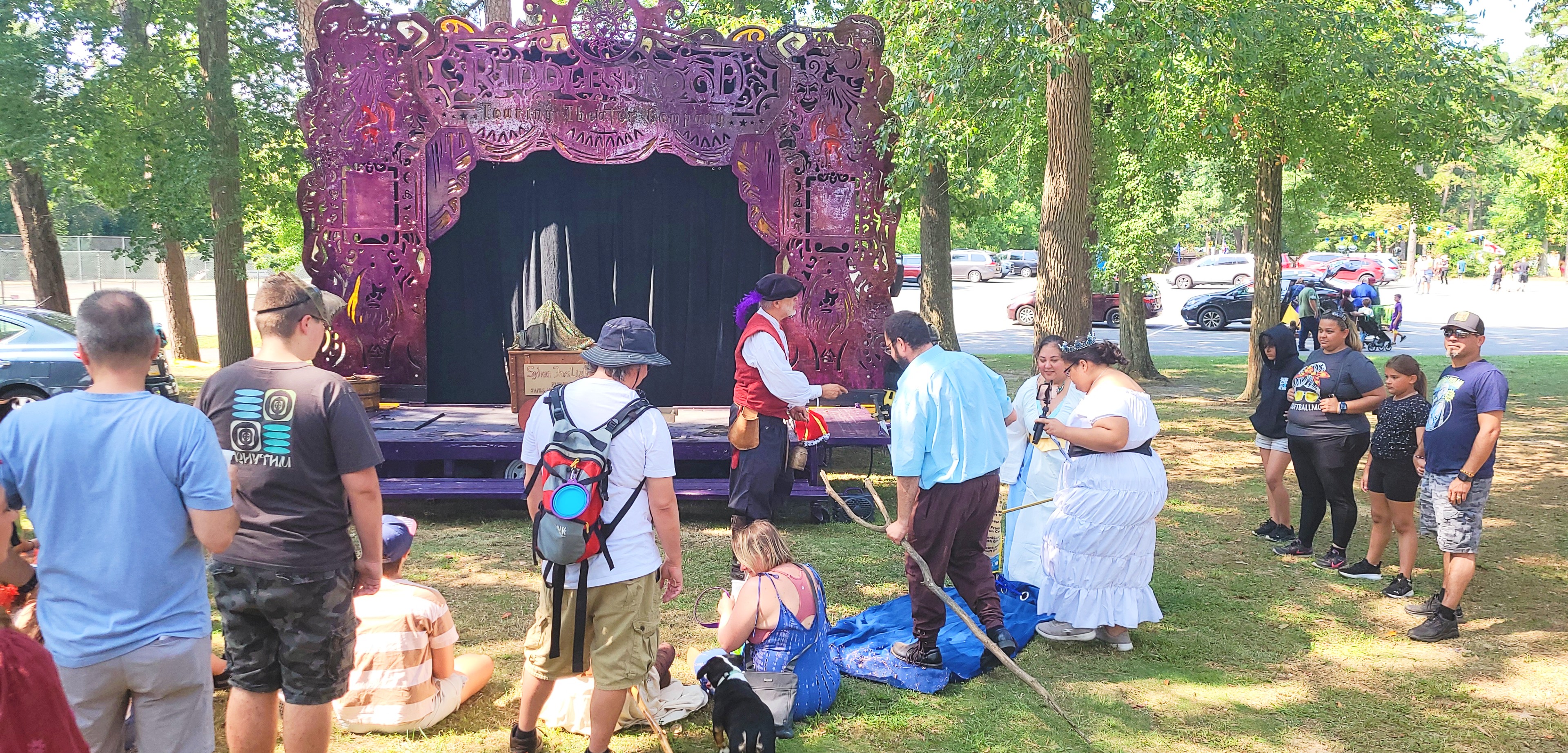 A touring theater company performing an immersive outdoor show for families and festival-goers