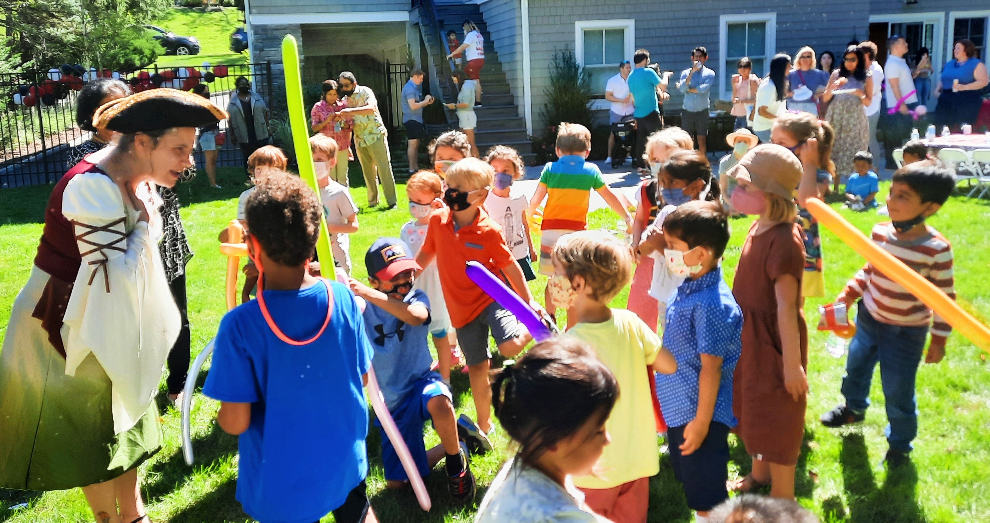 Kids cheering and laughing as actors perform an engaging story at a PA summer kids camp event.