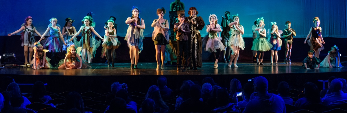 Group of young actors performing a musical in a New Jersey community theater