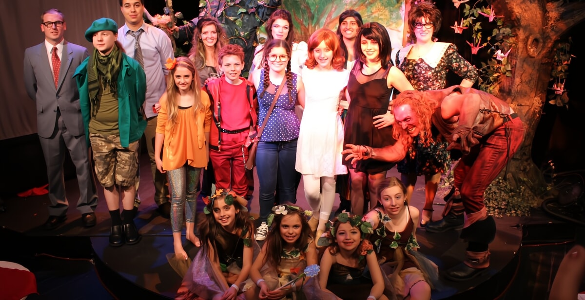 Smiling children taking a bow after a community theater performance in NJ