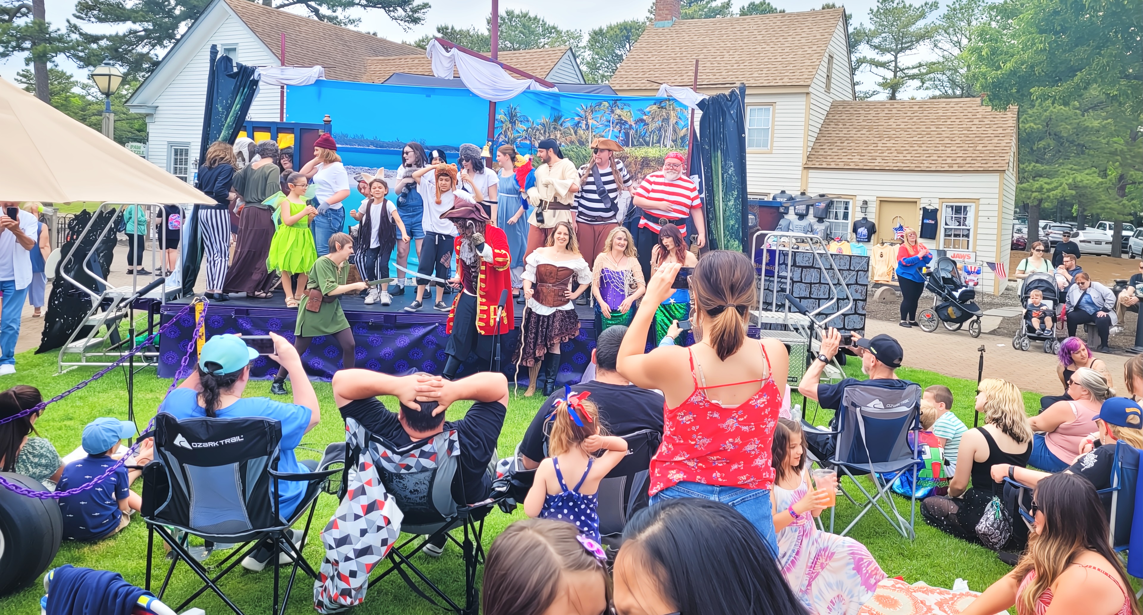 Costumed actors performing an interactive show at a vibrant South Jersey festival