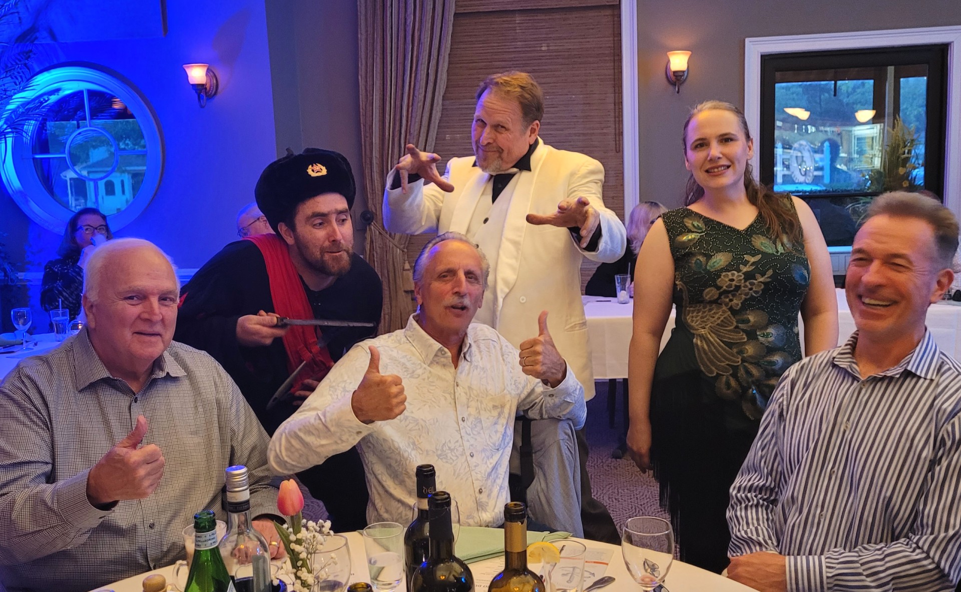 Actors dressed as Houdini and other characters performing in a hilarious comedic murder mystery show