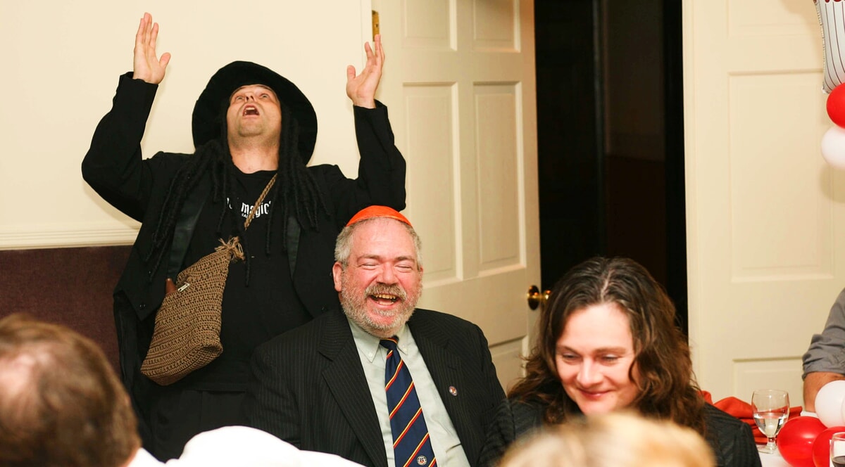 A hypnotic gaze as a man reads a participant’s thoughts, symbolizing the psychological excitement of a murder mystery experience.
