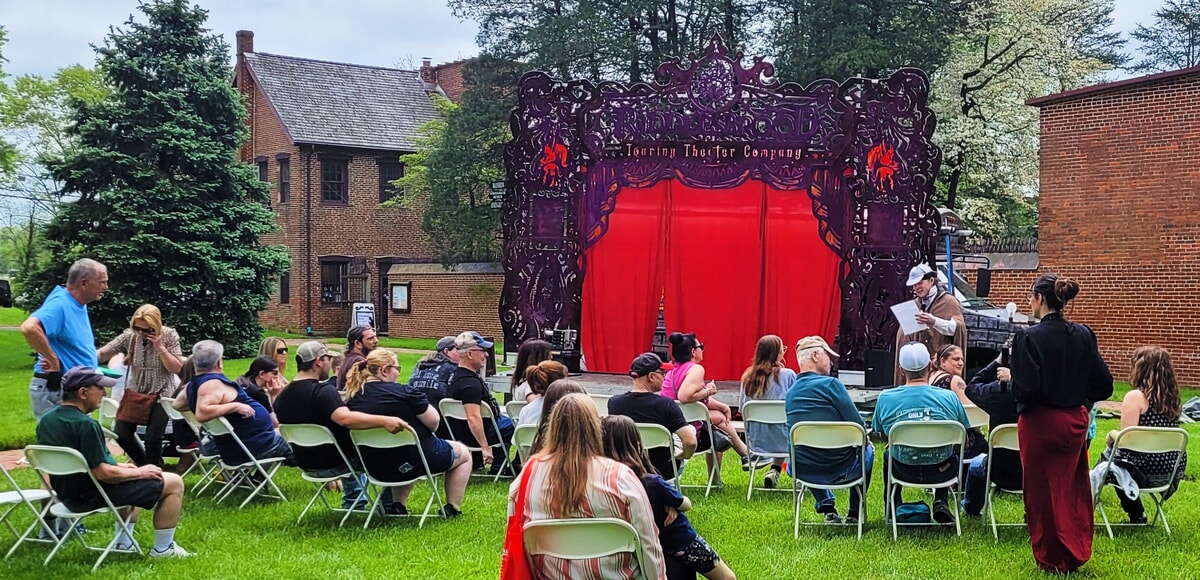 Actors bringing audience members on stage during an outdoor entertainment event in NJ & PA.