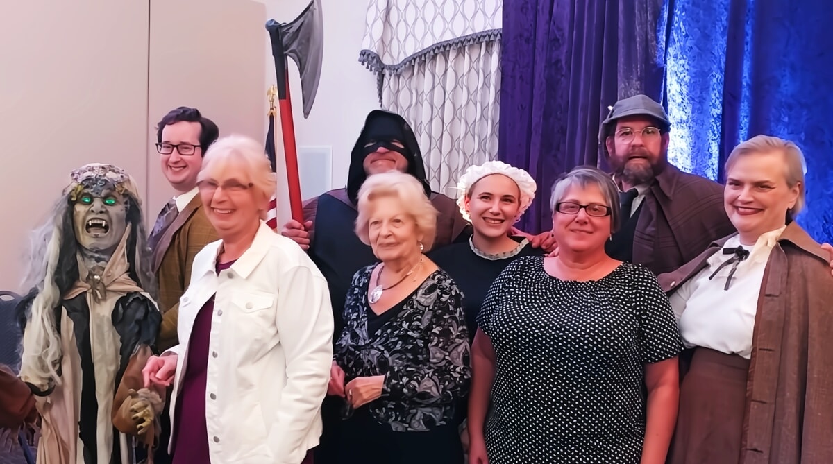 Actors and audience members reacting to a shocking twist in a PA murder mystery show