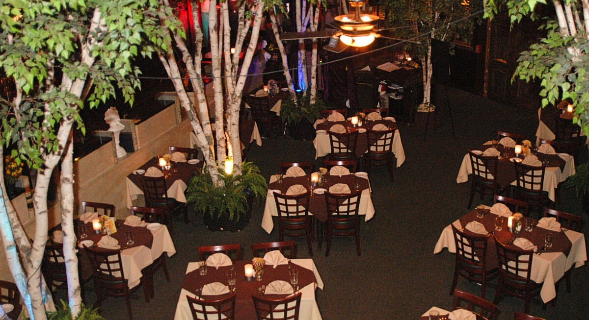 A dramatic table setting for a murder mystery dinner featuring themed props, elegant place settings, and immersive details