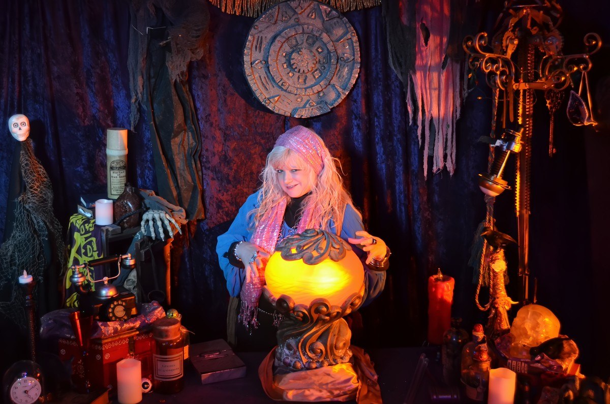 The Madam looking into her crystal ball