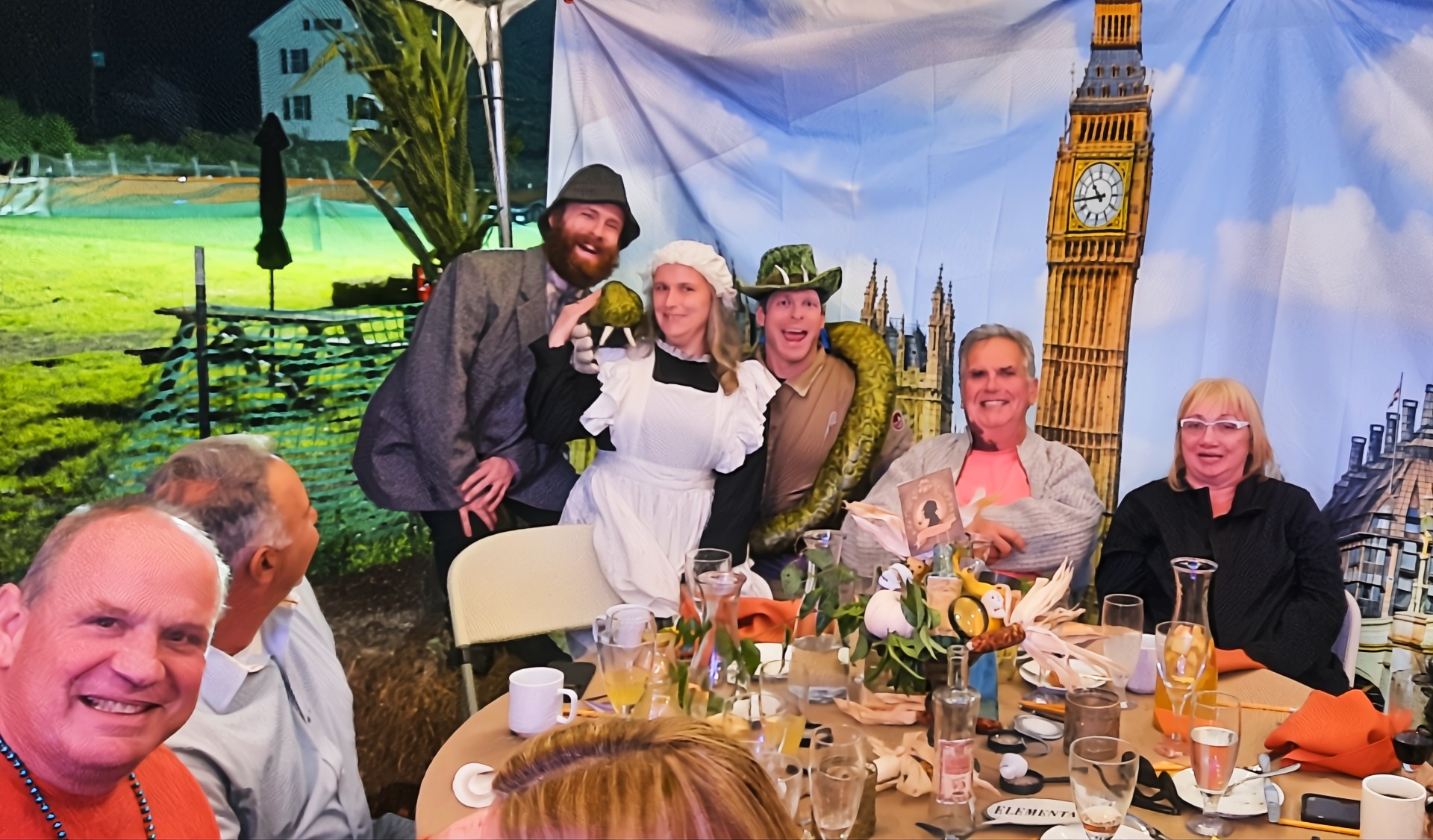 Guests enjoying a suspenseful outdoor murder mystery staged by a professional company in a rural area
