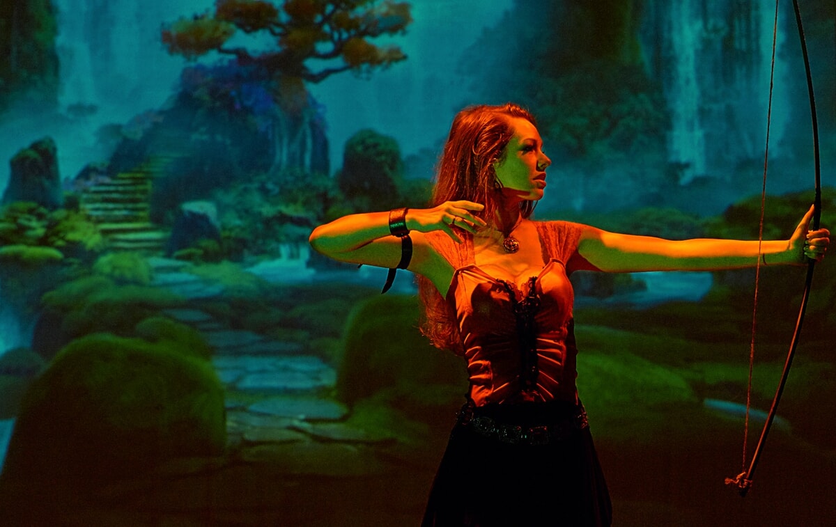 Actors engaged in an intense stage combat sequence during the 'Harken' mainstage theatrical performance.