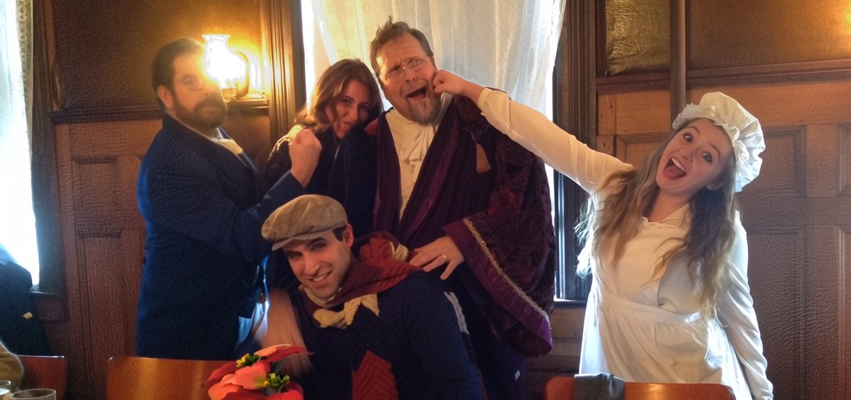 Actors dressed as Charles Dickens characters delighting guests at a festive corporate event