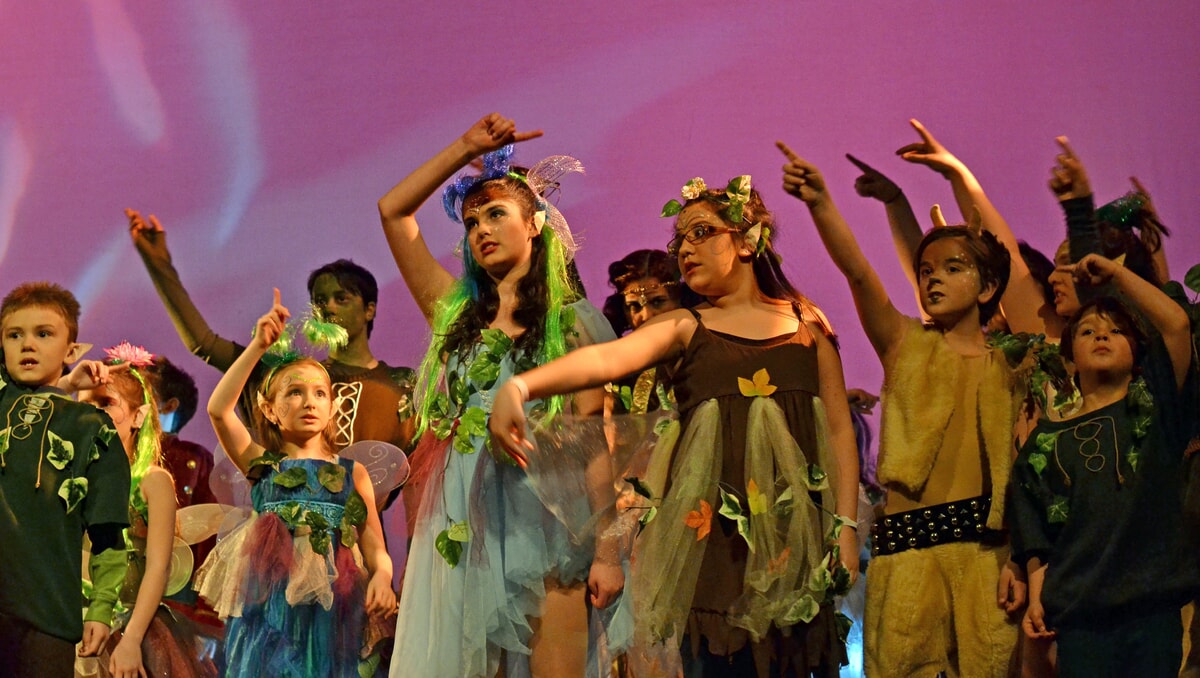 Fairies singing the Riddlesbrood theme song, filling the air with magic and melody