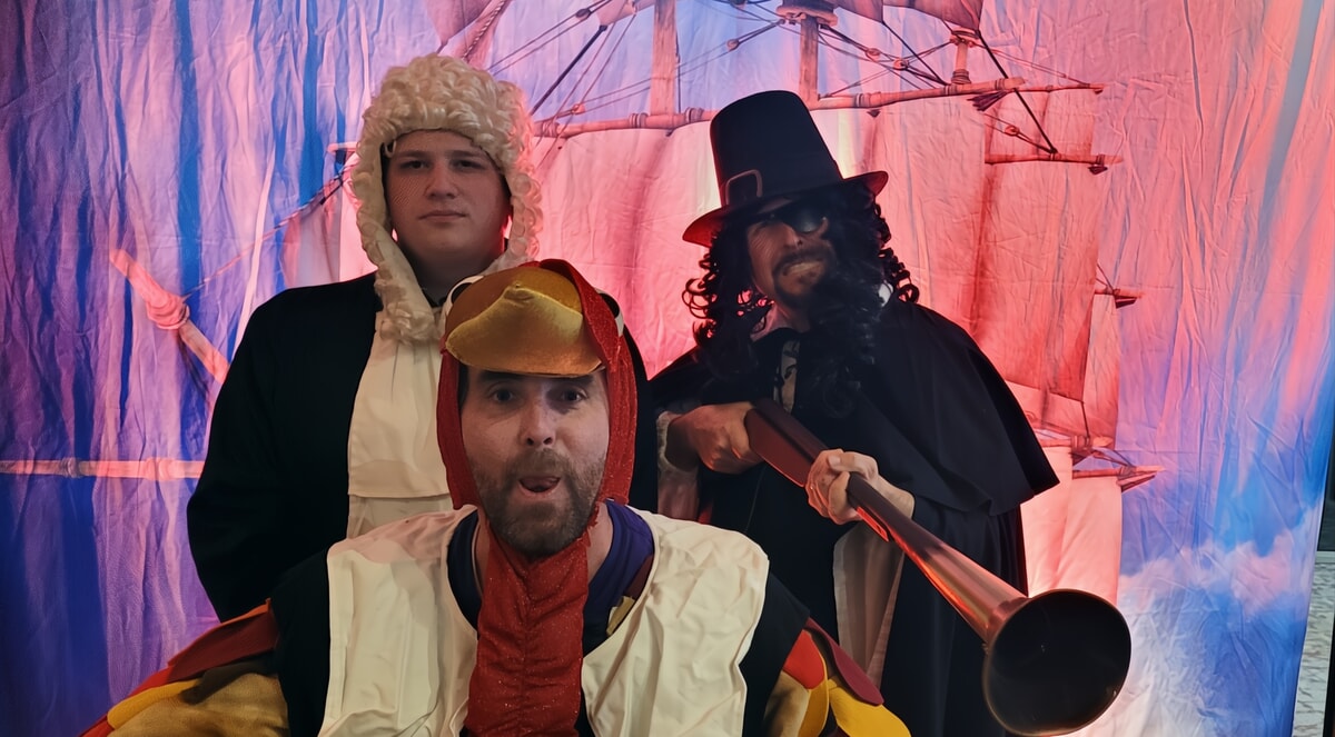 The actors of "The Mayflower Murder" posing together in their colonial costumes, bringing laughter, intrigue, and interactive fun to this November murder mystery.