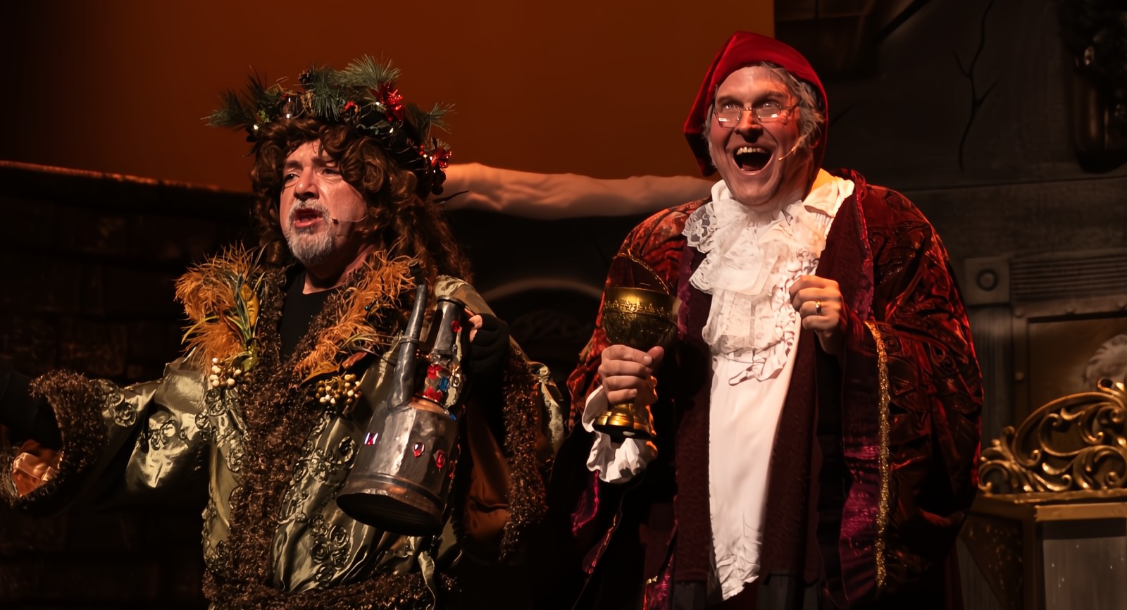 Actors portraying Ebenezer Scrooge and Bob Cratchit in a heartwarming national touring theater show