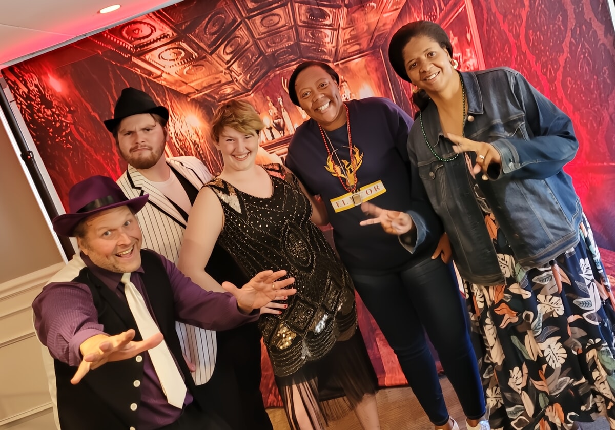 1920s speakeasy-themed dinner table with feathered centerpieces, vintage glassware, and Art Deco elements—A stylish choice for choosing the perfect theme