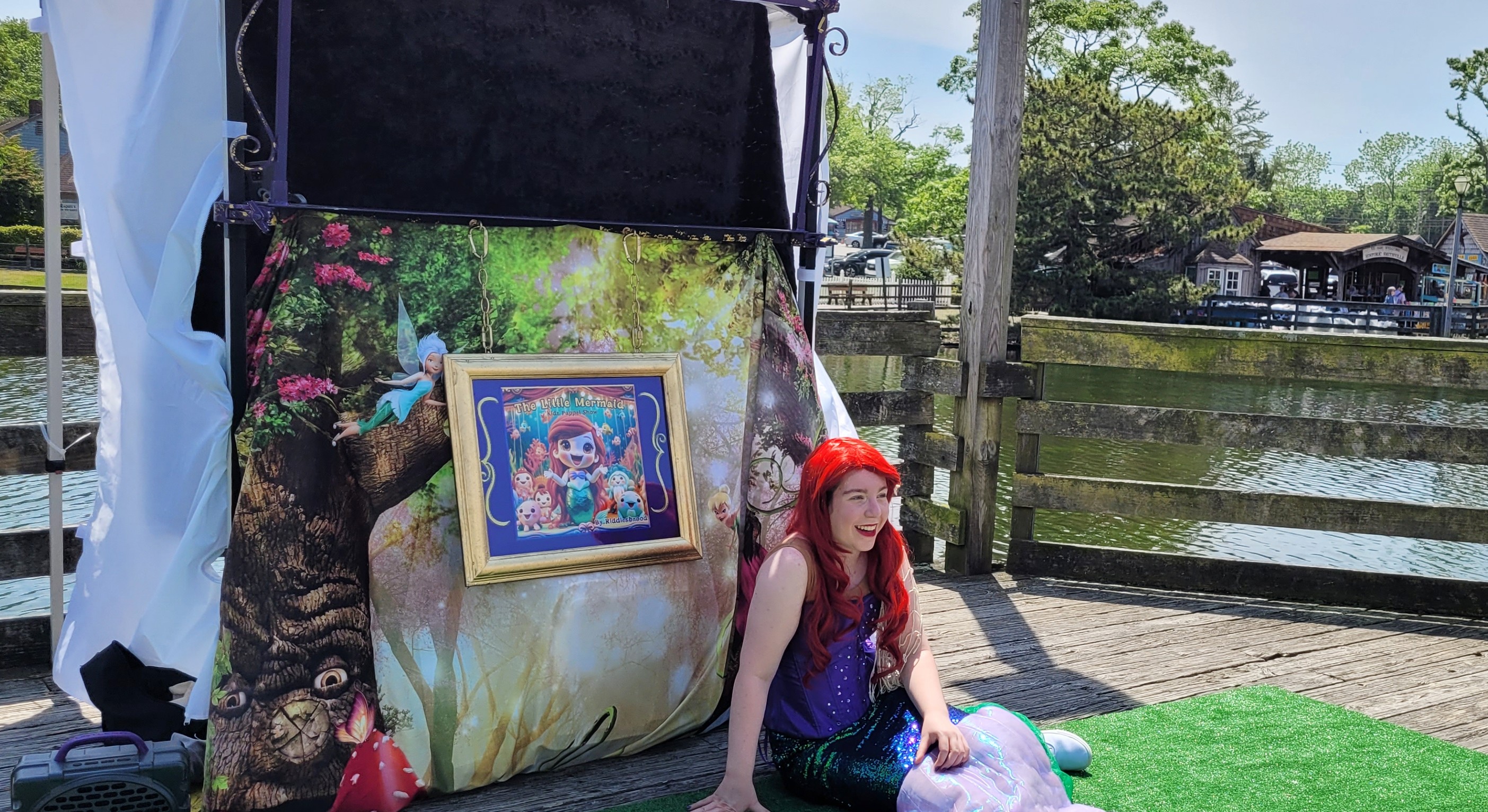 An actor dressed as the Little Mermaid performing in a kids' puppet show at Historic Smithville, captivating young audiences