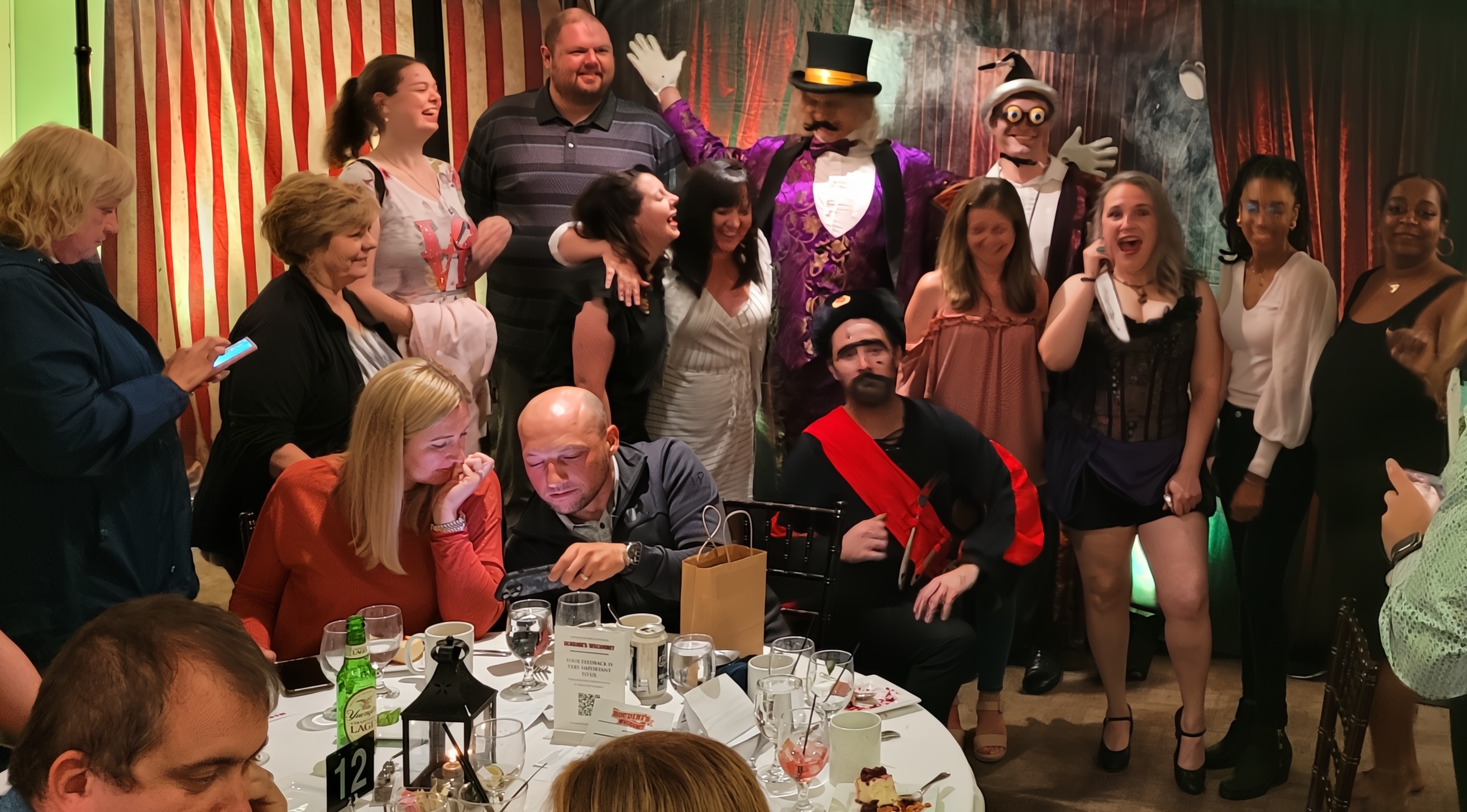 Actors in colorful costumes revealing the murderer in a Peddlers Murder Mystery Party performance