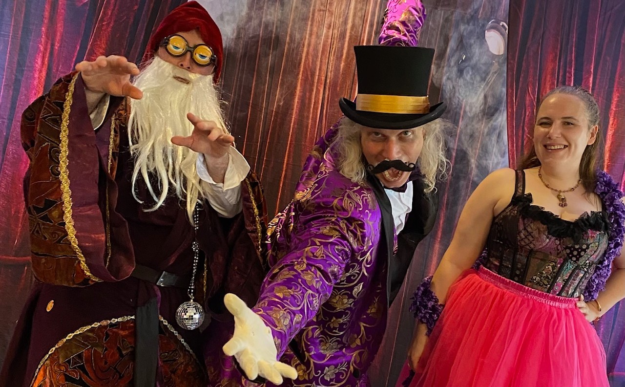 A dramatic moment as a Houdini character reveals a shocking twist in a comedic murder mystery performance