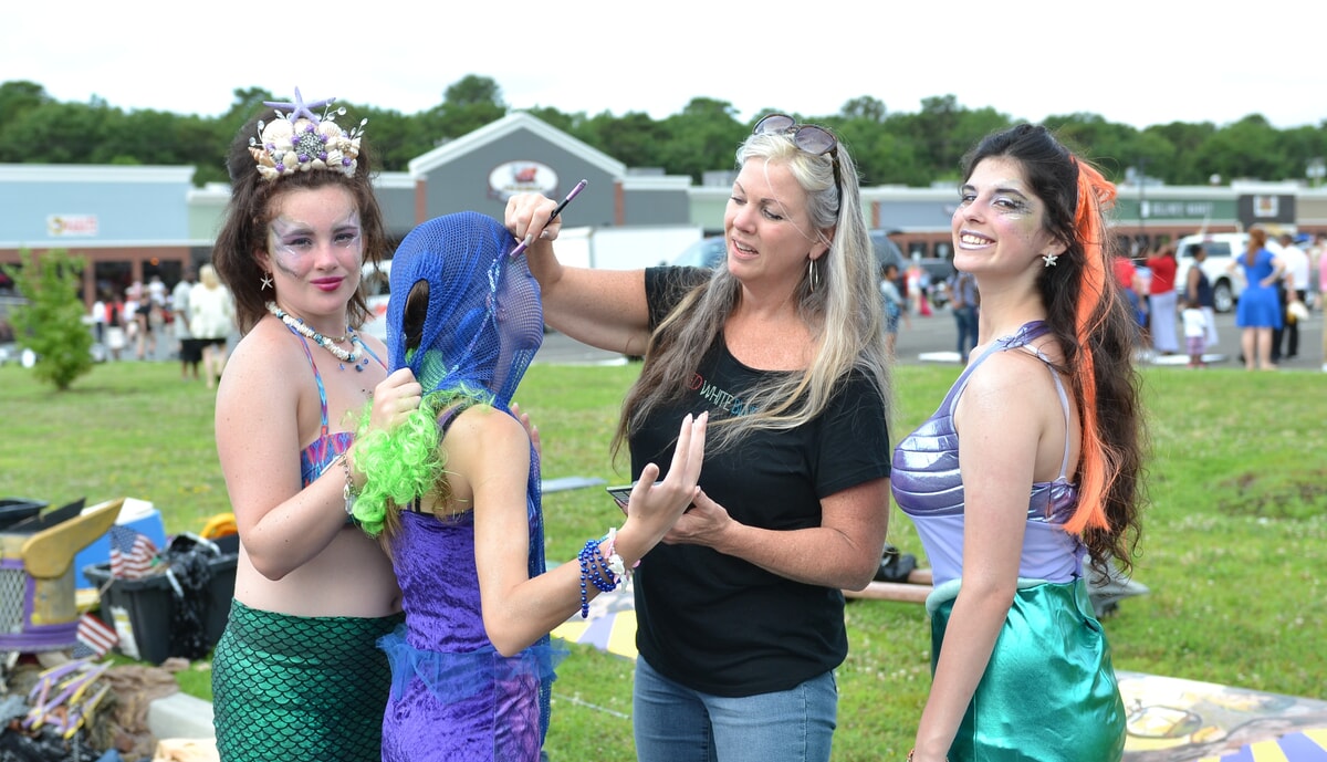Actors dressed as fairies entertaining the crowd in a parade—A perfect example of fun community involvement