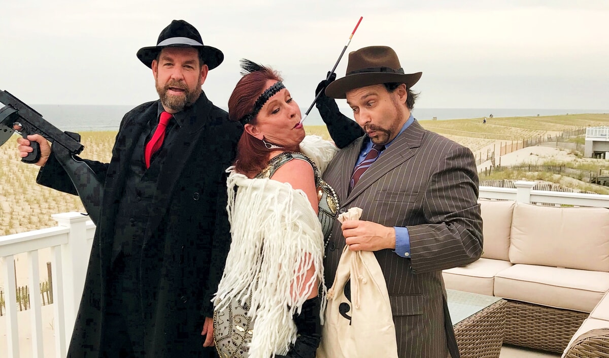 Audience members participating in a fun summer murder mystery game