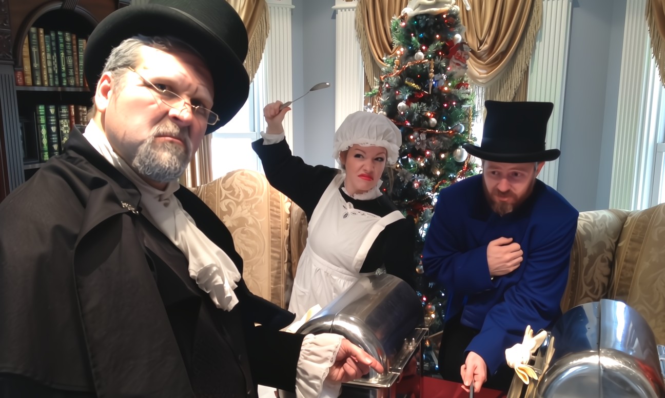Victorian-costumed actors dramatically reenacting a scene from a Christmas Murder Mystery show.