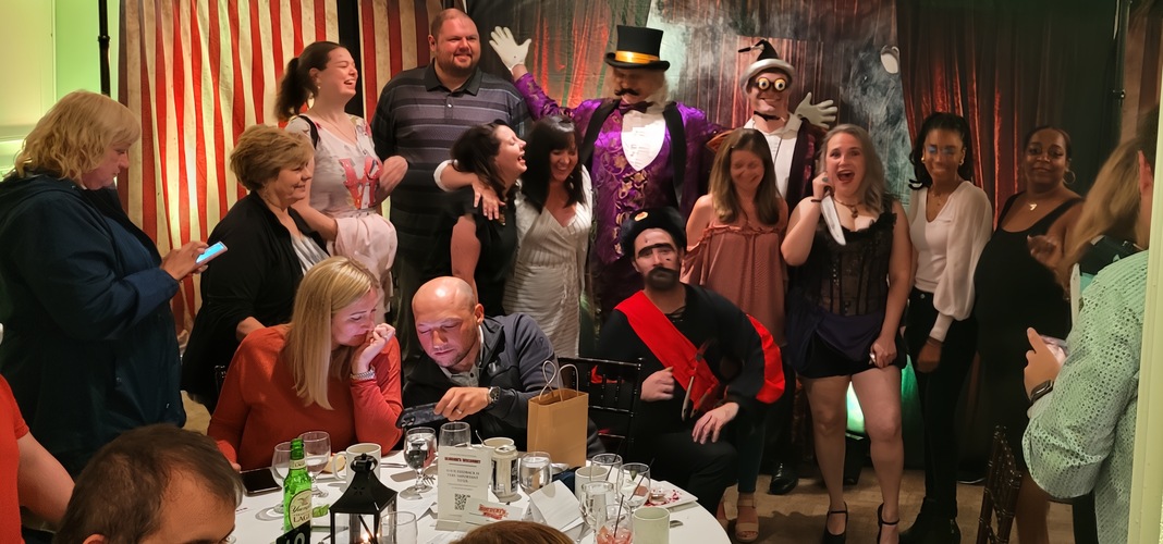A theatrical performance featuring a detective and suspects at a dinner theater event.