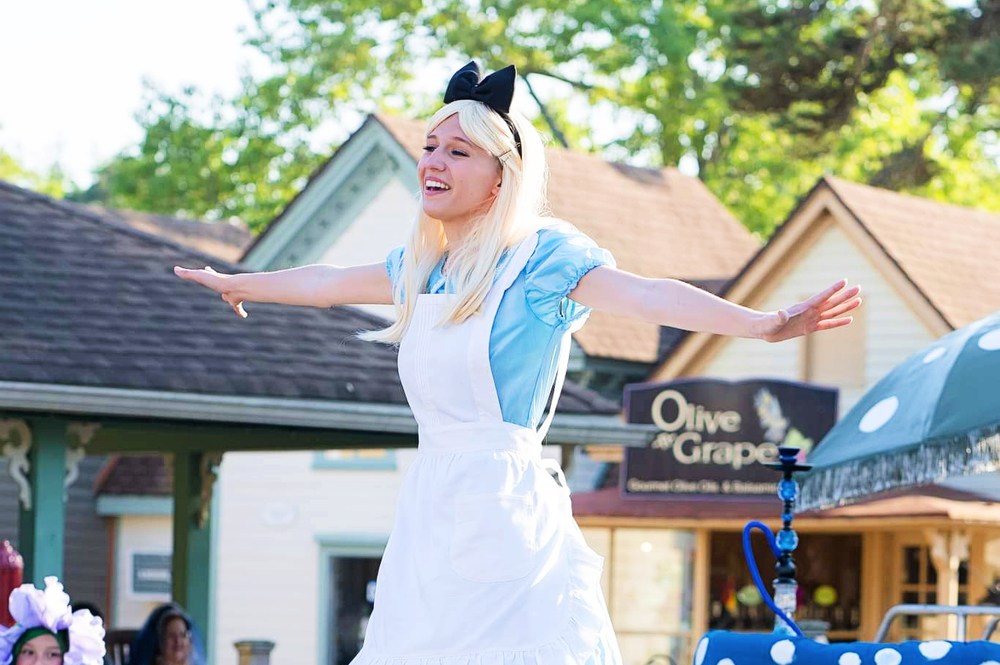 A vibrant scene from an outdoor show, featuring talented performers and a cheering audience.
