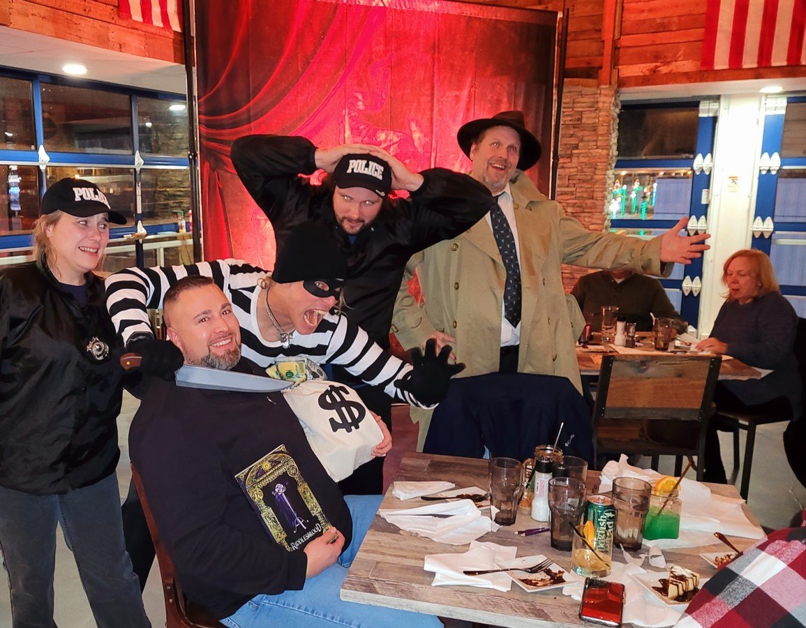 Theatrical performers in themed costumes engaging in a NJ murder mystery show