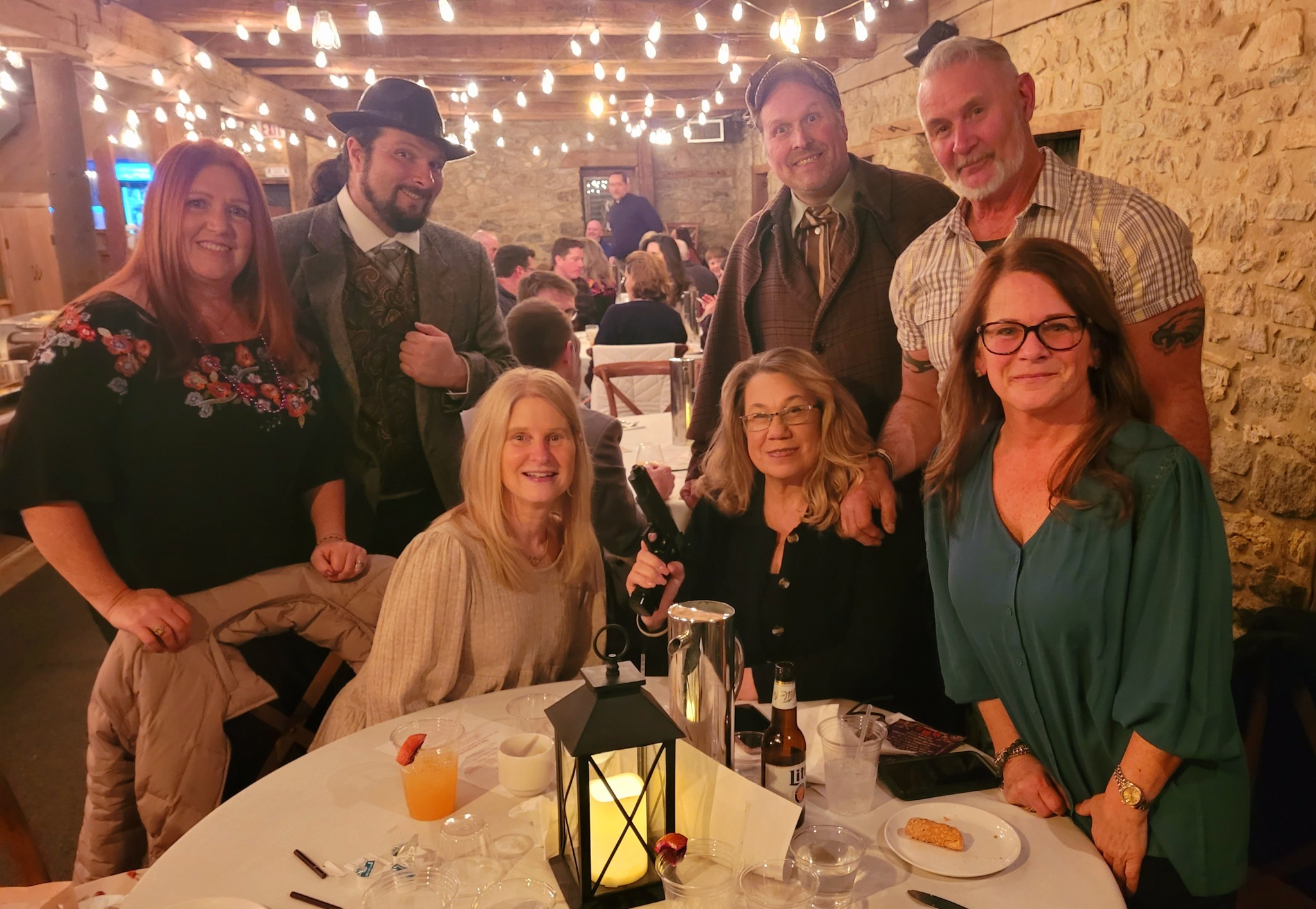 A dinner theater audience immersed in a thrilling mystery performance.