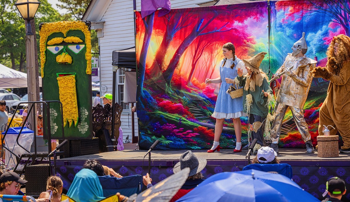 A festive outdoor event featuring a live performance in a scenic setting.