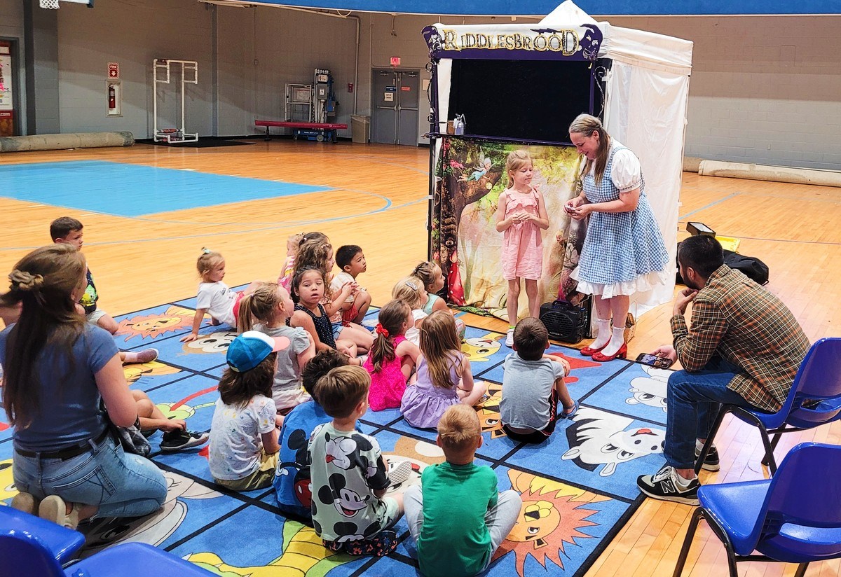A vibrant scene from a touring kids' show, captivating young audiences with colorful characters