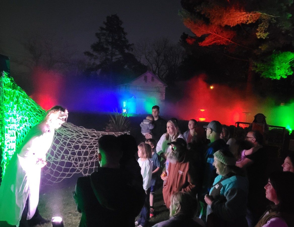 Touring haunt setup with eerie lighting and fog machines at a mobile event
